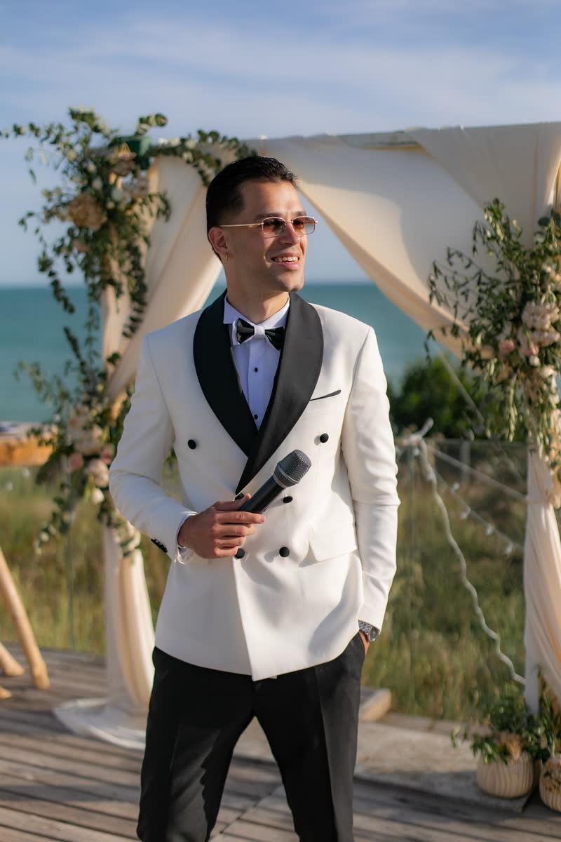 Vova with a microphone at a seaside ceremony in Cadiz