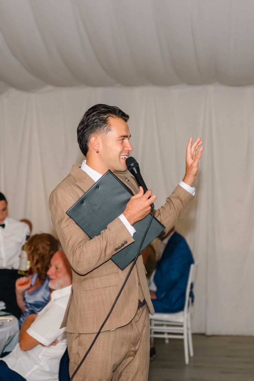 Vova speaking to guests during an evening celebration