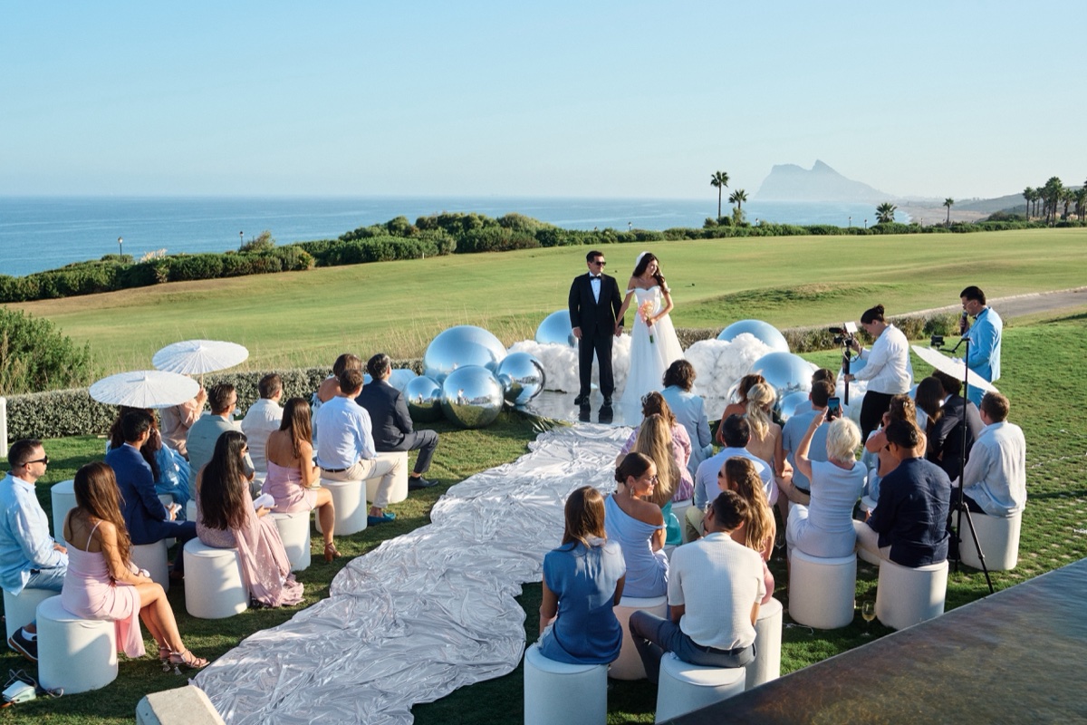 Liza and Max at their ocean-view ceremony with Vova officiating