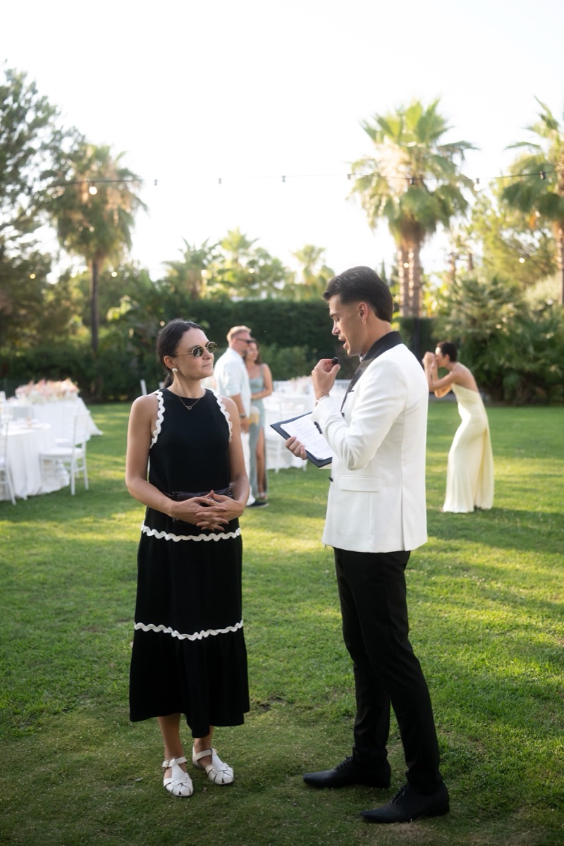 Vova interviewing a guest on the lawn during the cocktail hour